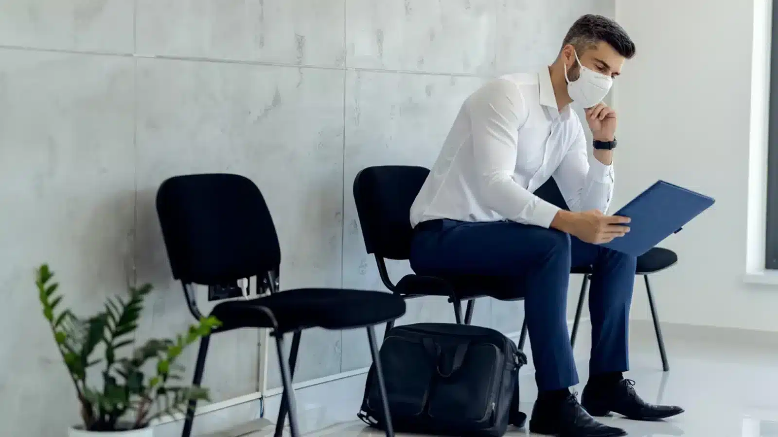 Professional reviewing severance and termination paperwork while consulting an employment lawyer.